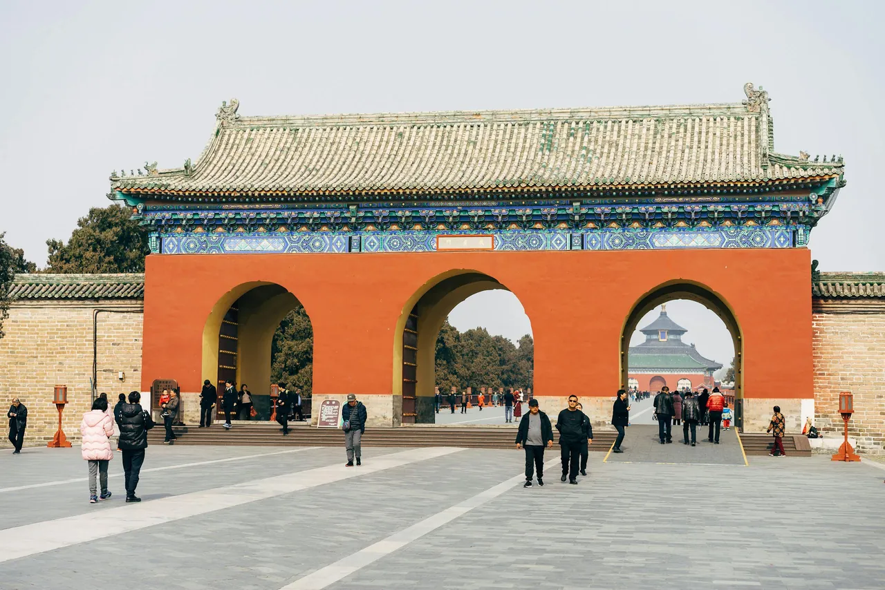 People walking in front of an archway in china