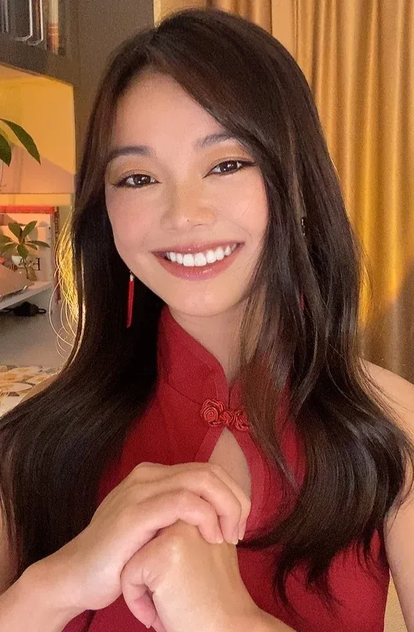 Cristina smiling in a red qipao